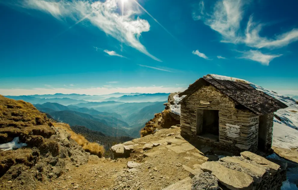 brown wooden house on mountain cliff